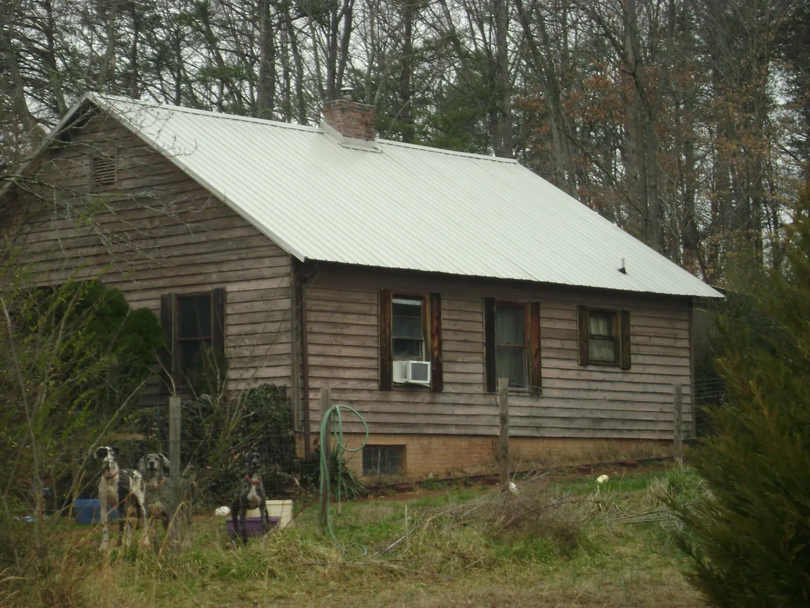 White metal roof on an old wood sided farmhouse, from a Metal Roof Installation job in Tiffin